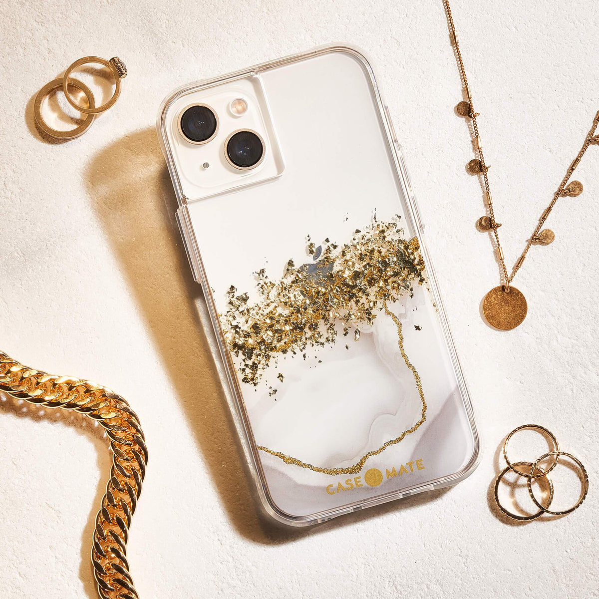 Case-Mate Karat Marble iPhone 13 case with gold accents, styled with jewellery